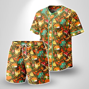 May include: A short-sleeve button-down baseball jersey and matching drawstring shorts set featuring an all-over print of cartoon creatures, pumpkins, and mushrooms on a dark brown background with teal trim along the collar and sleeves.