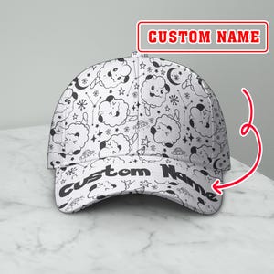 May include: White baseball cap with a repeating pattern of cartoon clouds, stars, and UFOs. The text "CUSTOM NAME" is printed on the front of the cap. The cap is designed with a curved brim.