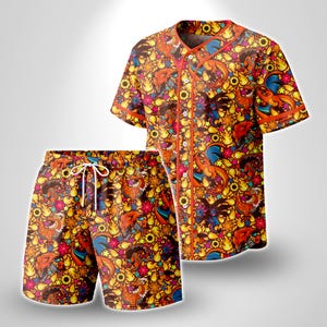 May include: A short-sleeve button-down baseball jersey and matching shorts set featuring an all-over vibrant print of orange dragon-like creatures, yellow flames, suns, and colorful stars against a dark background with orange trim details.