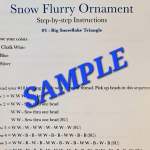 May include: A page from a craft instruction guide titled "Snow Flurry Ornament." The guide provides step-by-step instructions for creating a snowflake triangle, with color choices and bead sequences. A blue "SAMPLE" watermark is across the page.