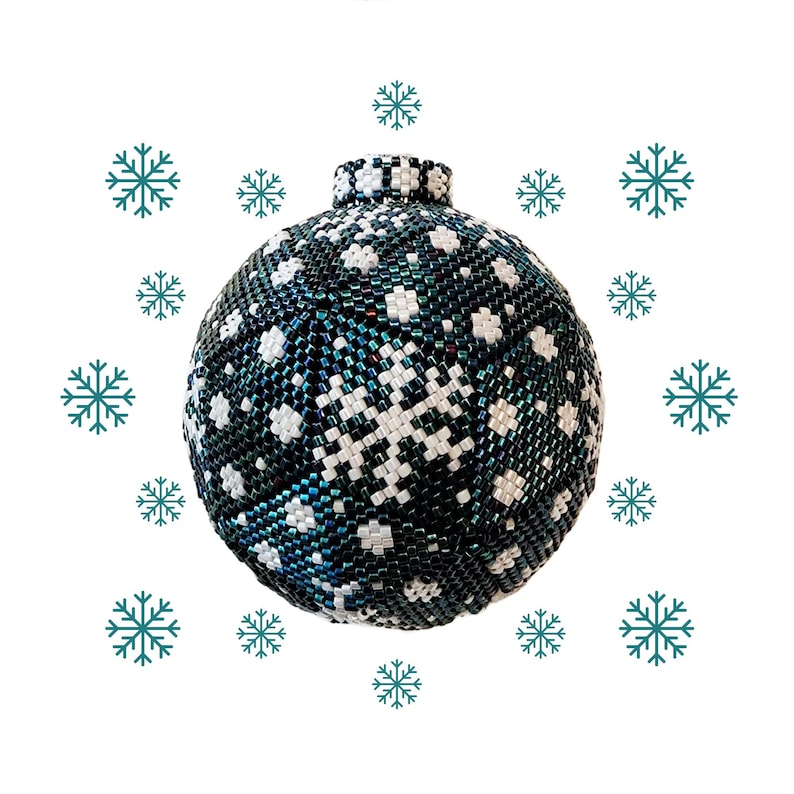 May include: A beaded Christmas ornament with a dark teal and white snowflake design. The ornament is round with a small, beaded top. Teal snowflakes are scattered around the ornament against a white background. This festive decoration is perfect for the holiday season.