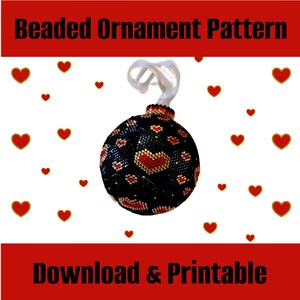 May include: A beaded Christmas ornament pattern featuring a black sphere with red and gold hearts. The pattern is downloadable and printable. The image is surrounded by red hearts.