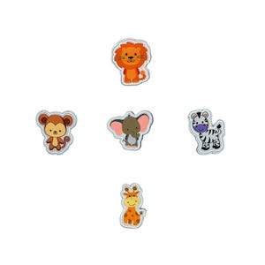 May include: Five iron-on patches featuring various jungle animals. The patches are white with a black outline and feature a lion, monkey, elephant, zebra, and giraffe.