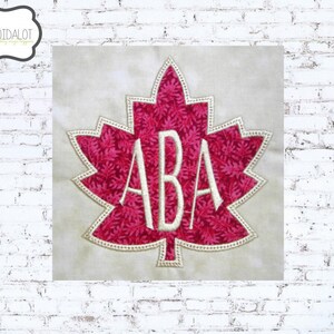 May include: A red maple leaf with a white outline and the letters "ABA" inside. The leaf is on a beige background.
