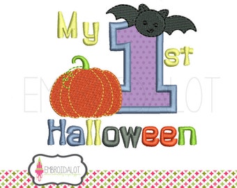 May include: Embroidered design featuring a pumpkin, a bat, and the text "My 1st Halloween". The design is in various colors, including orange, green, purple, and yellow.