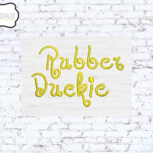 May include: Yellow embroidered text on a white fabric background that reads "Rubber Duckie".