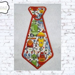 May include: An orange embroidered tie with a white background and a pattern of colorful robots. The tie is shaped like a traditional necktie.