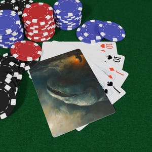 May include: Poker set with playing cards and poker chips. The playing cards feature a fantasy illustration of a sea creature. The poker chips are red, black, and blue. The playing cards show the number 10 and the suits of hearts, diamonds, and spades.