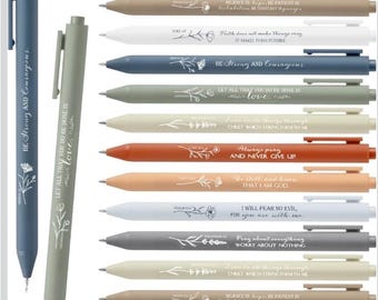 May include: A collection of pens in various colors, including black, beige, white, and blue. Each pen features inspirational quotes and floral designs. The pens have a sleek, modern design with a clip.