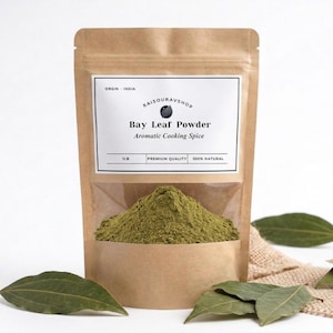 May include: A white ceramic mug with a black handle and the text "But First, Coffee" in a bold, black font. The mug is set against a neutral background, highlighting its simple design.