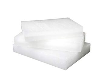 May include: Three rectangular blocks of white, semi-translucent wax stacked on top of one another. Each block has a smooth, flat surface and sharp, defined edges, creating a layered appearance with a consistent, solid white color throughout.
