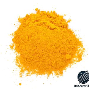 May include: A pile of bright yellow turmeric powder against a white background. The spice is finely ground and has a slightly textured appearance. The image is well-lit, highlighting the vibrant color of the turmeric.