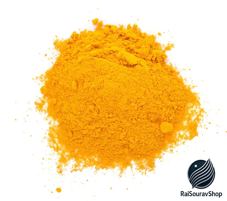 May include: A pile of bright yellow turmeric powder against a white background. The spice is finely ground and has a slightly textured appearance. The image is well-lit, highlighting the vibrant color of the turmeric.