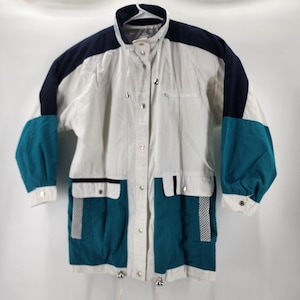 May include: A vintage white, teal, and navy blue jacket with a collared neckline and snap closures. The jacket features teal sleeves and pockets, with a checkered pattern detail. A drawstring is visible at the waist and hem.