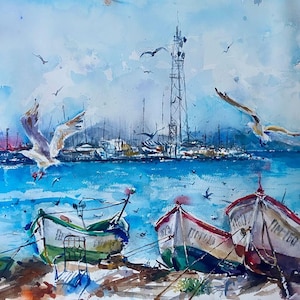 May include: Watercolour painting of a coastal scene with boats and seagulls. Three colourful boats are beached on the shore, with a harbour and a tall structure in the background. Several seagulls are flying in the sky above the water.