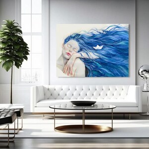 May include: A rectangular wall art print featuring a painting of a figure with pale skin and long, flowing blue hair. A small white paper boat rests within the hair. The figure has closed eyes and rests their head on their arms in a calm pose.
