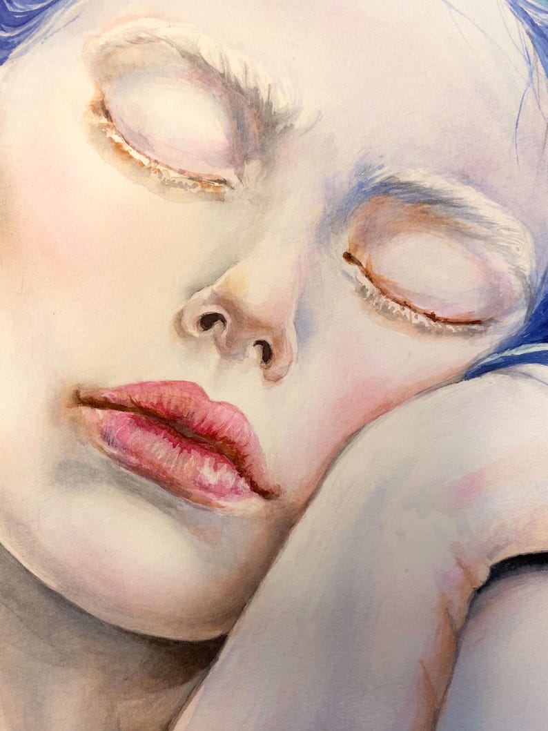 May include: A watercolor painting of a face with closed eyes, pale skin, and pink lips. The figure has vibrant blue hair visible at the top and rests their head on a hand. The artwork features soft shading, delicate brushstrokes, and cool tones.
