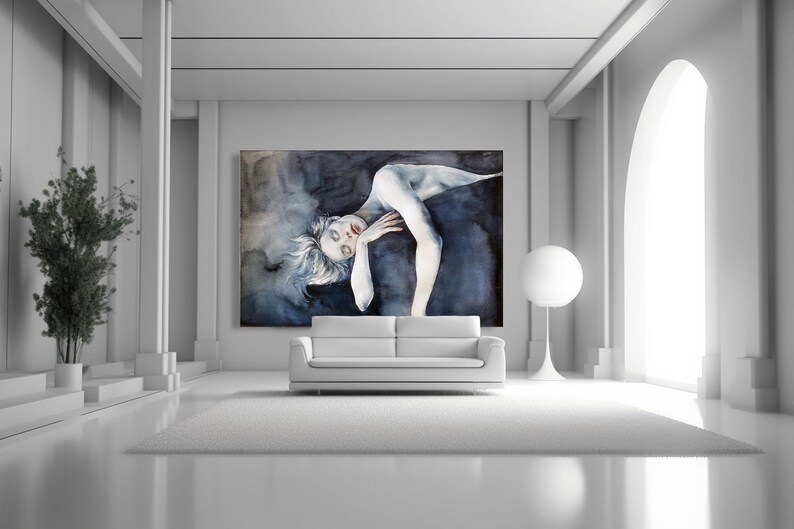 May include: A large rectangular wall art piece featuring a dark, moody watercolor painting of a reclining figure with pale skin and messy hair, set against a deep blue and black abstract background, displayed above a white sofa.