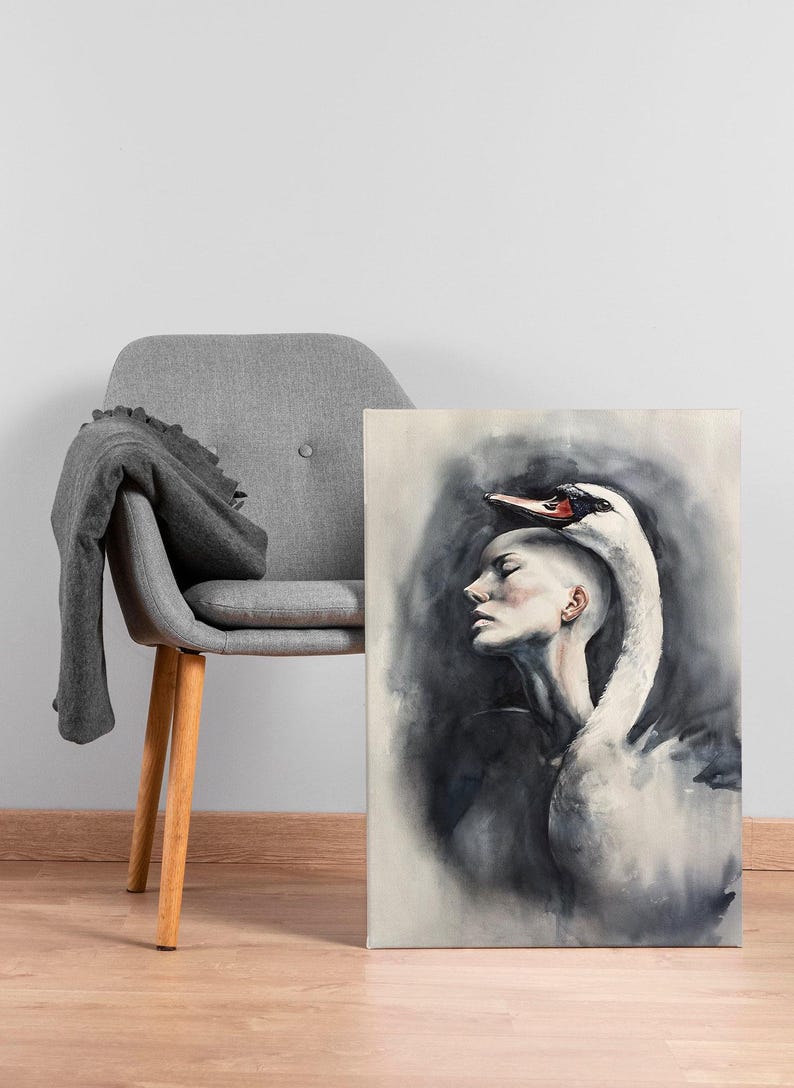 May include: A rectangular canvas print featuring a watercolor painting of a person with a shaved head in profile, with a white swan draped over their head and shoulders. The artwork uses shades of black, gray, and white with a red swan beak.