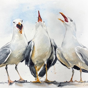 May include: A watercolor painting depicting three seagulls standing side by side. The birds have white heads, grey and black wings, and yellow legs. Each seagull has its beak open, facing upward or forward, against a light blue wash background.