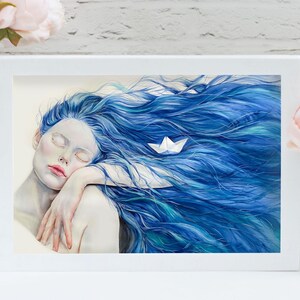 May include: A framed art print featuring a painting of a person with pale skin and long, flowing blue hair. A small white paper boat rests within the hair. The person has their eyes closed and is resting their head on their arm in a calm pose.