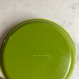 May include: A green plastic dish with the text "Made in USA 5002 3841" on the bottom.