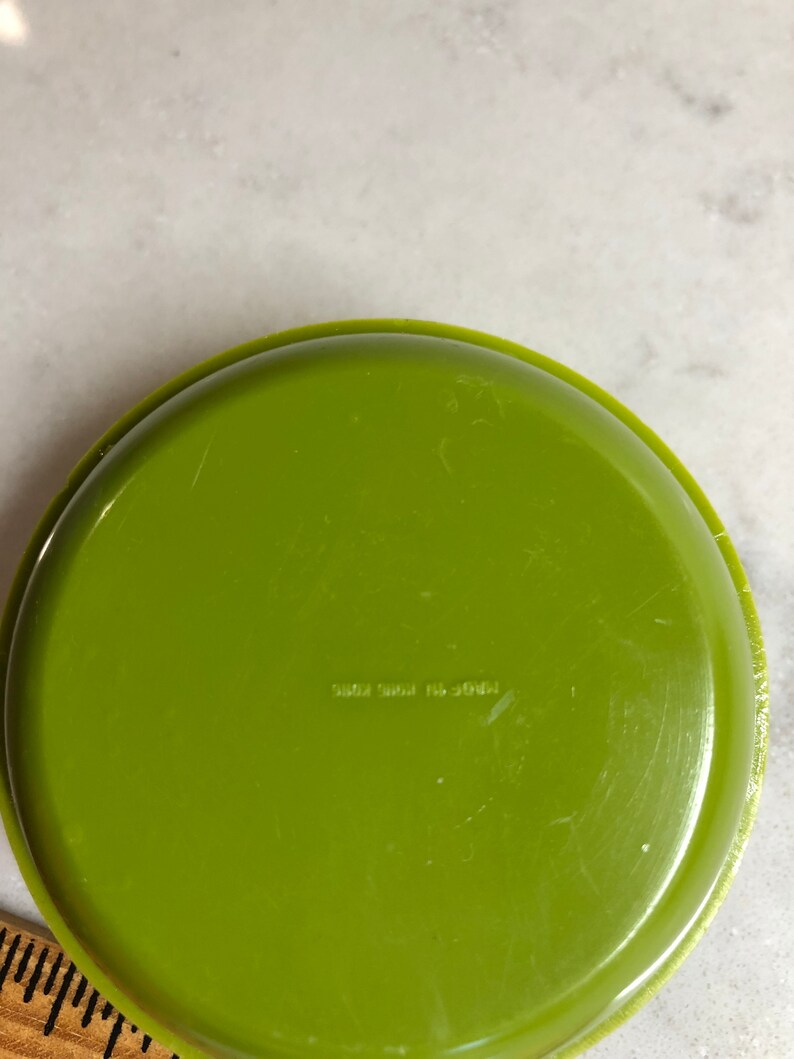 May include: A green plastic dish with the text "Made in USA 5002 3841" on the bottom.