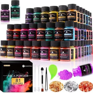 May include: A set of 81 jars of mica powder in various colors, including metallic and vibrant shades. The collection includes a black box labeled Mica Powder 81 Colors, two small spoons, a brush, tweezers, a green spatula, and three piles of flakes.