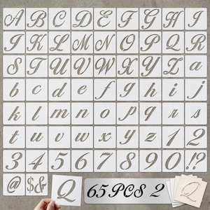May include: A set of 65 white plastic stencils featuring uppercase and lowercase cursive letters, numbers 0 through 9, and symbols including @, $, &, !, and ?. Each character is cut out from a square template. The text 65 PCS 2 is visible.