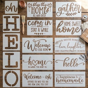 May include: A collection of white rectangular stencils featuring various phrases including "oh hello," "bless this home," "gather," "come in and stay a while," "home sweet home," "welcome to our home," "our house runs on love, laughter and inappropriate humor," "home is where the heart is," "hello," "welcome-ish," and "happiness is homemade."