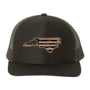 May include: A brown and black trucker hat with a distressed American flag design in the shape of the state of North Carolina.