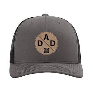 May include: A gray and black trucker hat with a brown circle logo that says "A D D" with a crossed out "A" and a semi-truck inside the circle.