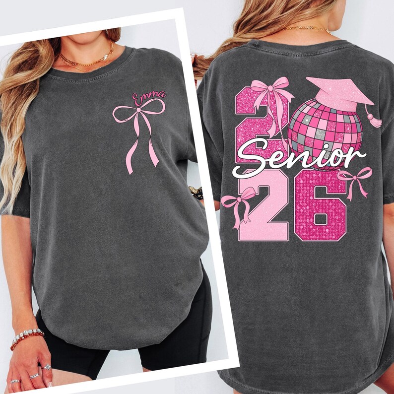 a woman wearing a gray t-shirt with pink ribbons and text on the back.