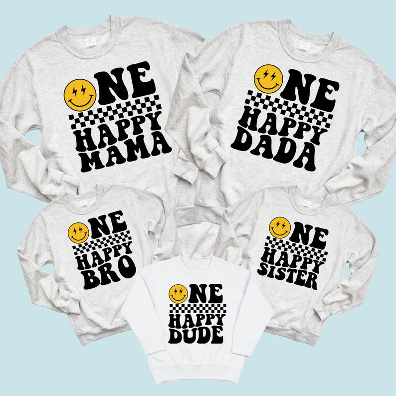 a collection of white sweatshirts with black text and smiley faces printed on them.
