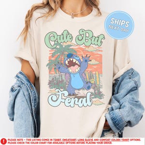 a woman wearing a t - shirt with a cartoon character on it