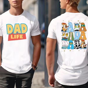 A man wearing a white t-shirt with a colorful graphic design on the back.