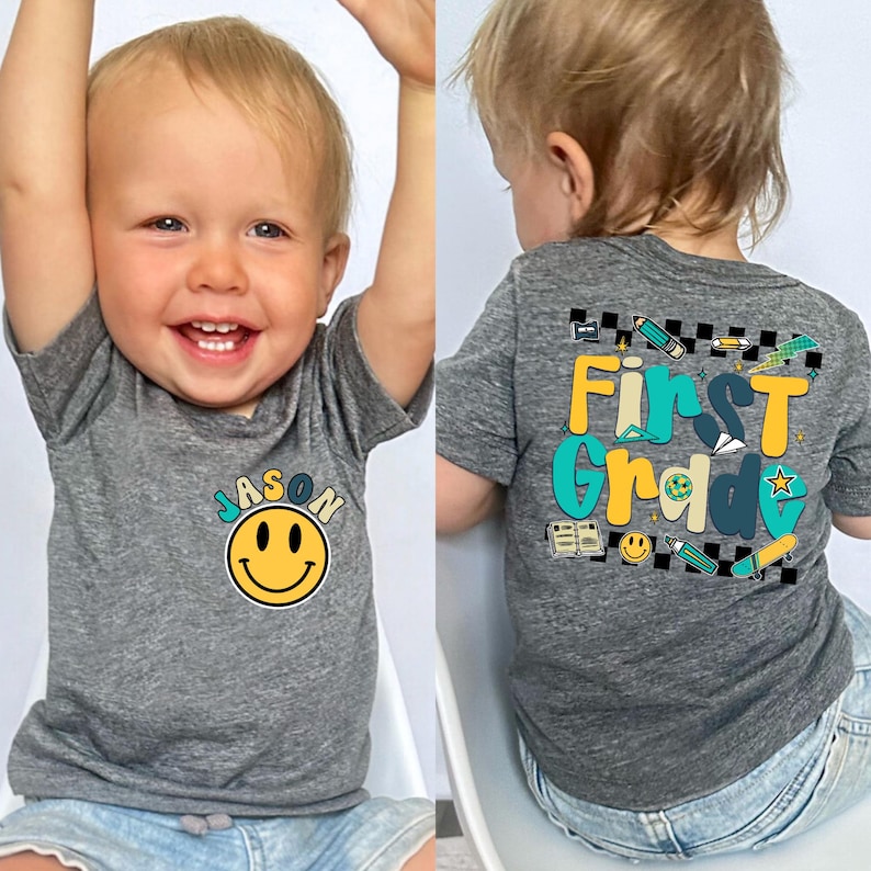 A smiling baby boy wearing a gray t-shirt with a smiley face and the name "JASON" printed on it.