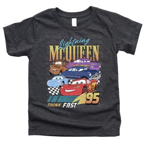 a black t - shirt with cars on it