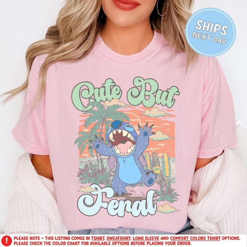 a woman wearing a pink shirt with a cartoon character on it