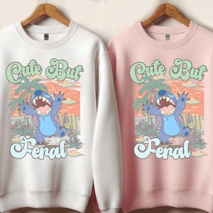 a couple of sweatshirts hanging on a wall