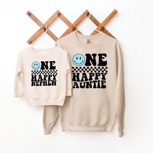 a couple of sweatshirts hanging on a wall