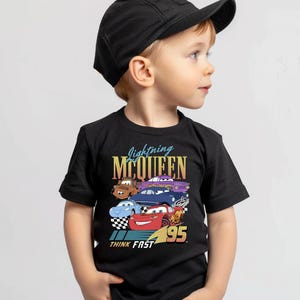 a young boy wearing a black hat and t - shirt