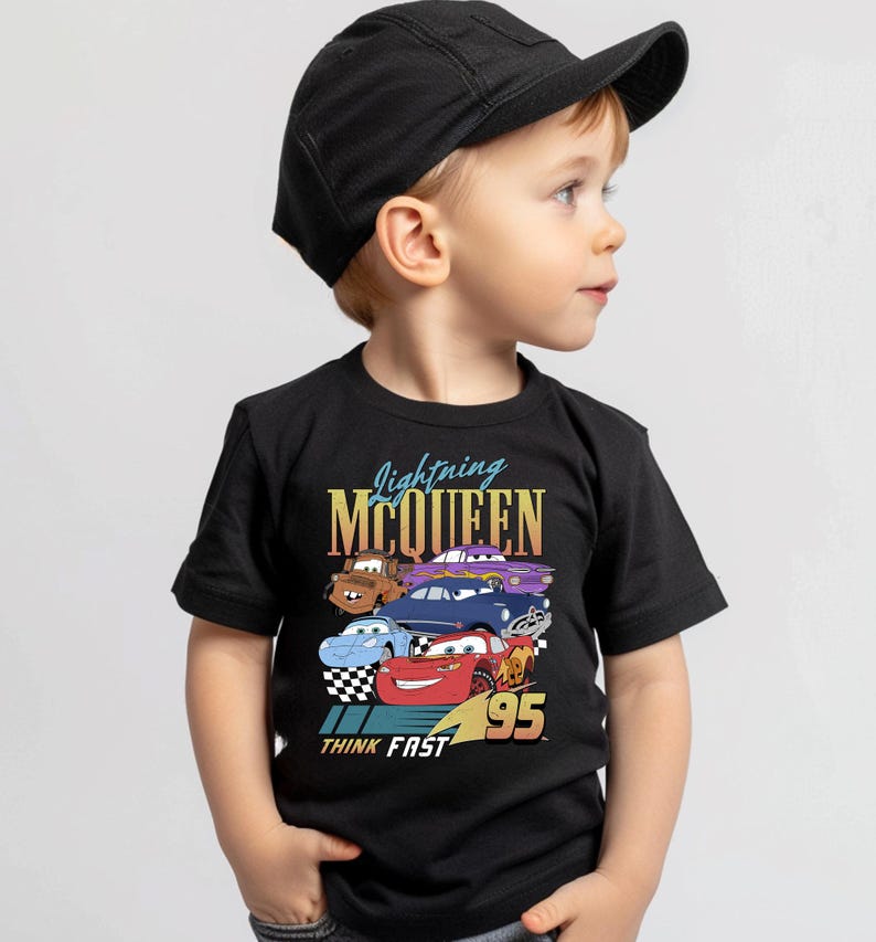 a young boy wearing a black hat and t - shirt