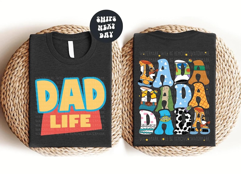 two t-shirts with the text "DAD LIFE" printed on them. The t-shirt on the left has the text "DAD LIFE" in a bold, colorful font, while the t-shirt on the right has the text "DAD LIFE" in a more playful, cartoon-like font. The t-shirts are placed on a woven mat, and there is a note indicating that the t-shirts are available in t-shirt, sweathirt, and long sleeve options.