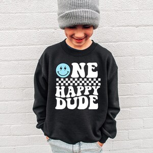 a young boy wearing a one happy dude sweatshirt