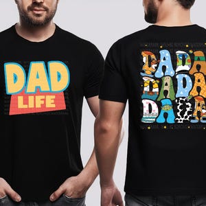 A man wearing a black t-shirt with a colorful graphic design on the front and back.