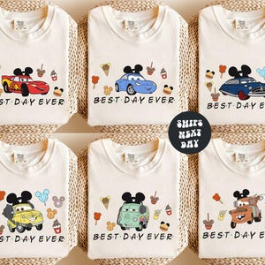 six white t-shirts with various cartoon car designs and the text "BEST DAY EVER" printed on them.
