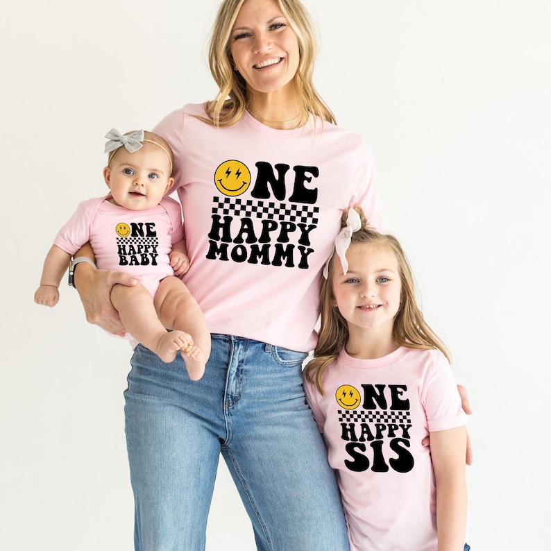a woman and two children wearing matching shirts