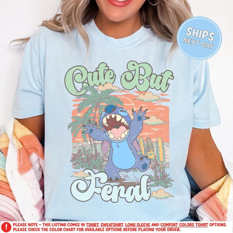 a woman wearing a blue shirt with a cartoon character on it