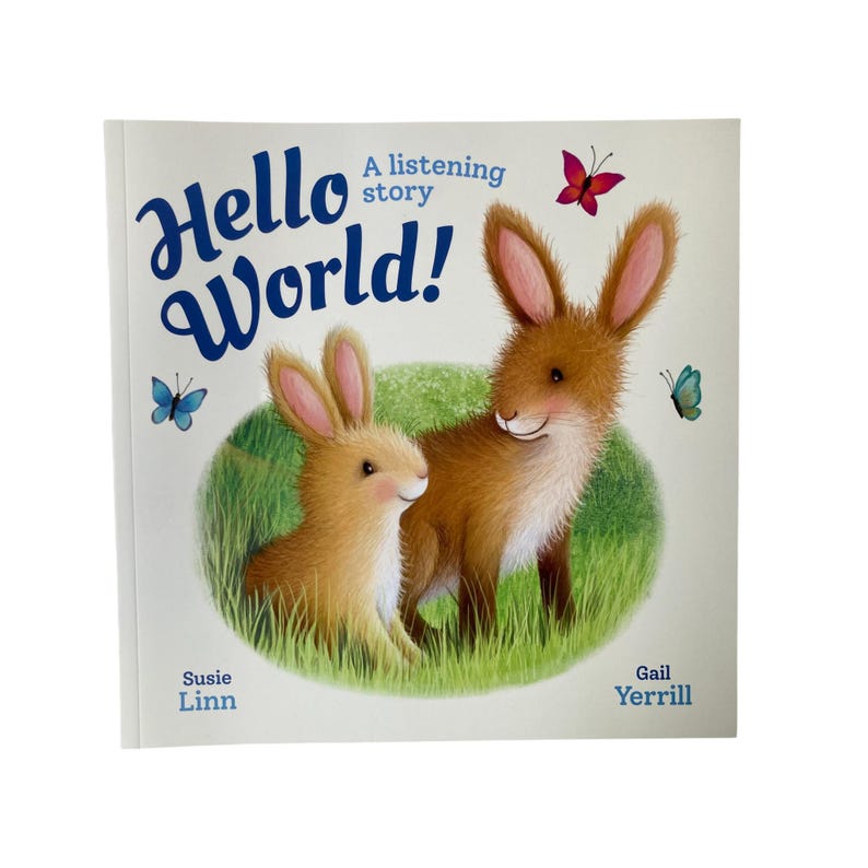 May include: A children's book titled Hello World! A listening story, featuring an illustration of two brown rabbits in green grass with blue and pink butterflies. The cover includes the author name Susie Linn and illustrator Gail Yerrill.